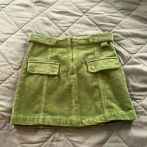 A green corduroy skirt, zips in the front